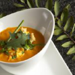Fiery Comfort: Pumpkin and Lentil Soup with Harissa Twist