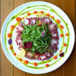Delicate Marinated Octopus Carpaccio with Fresh Microgreens
